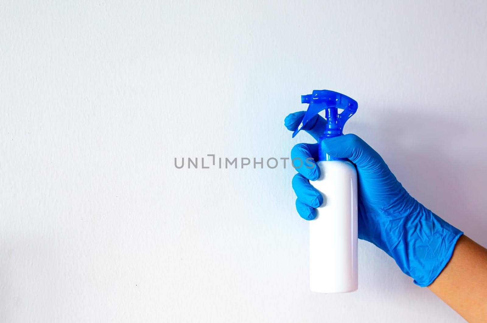 women hand with blue rubber glove and cleaning spray on white background