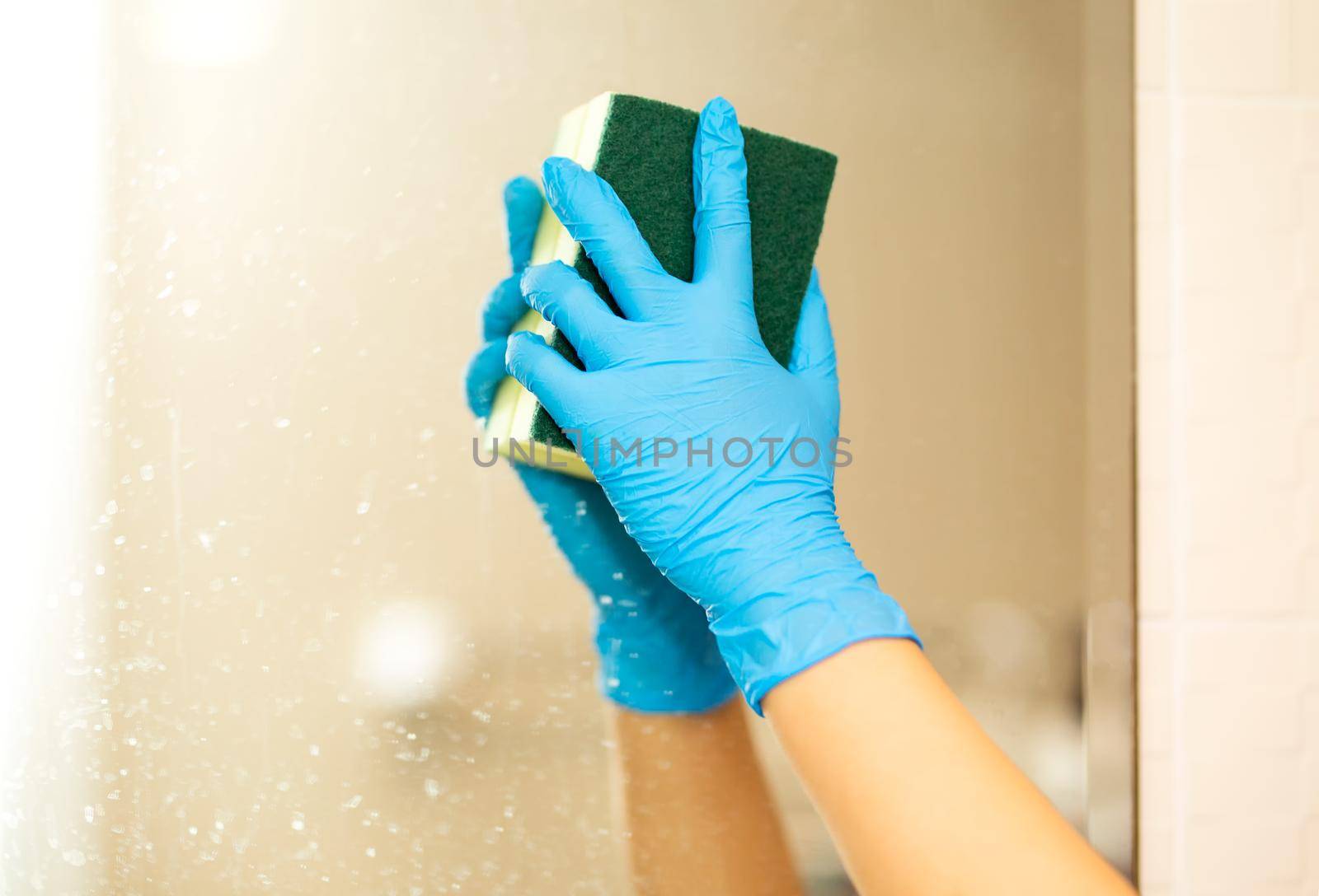 a hand in a blue rubber glove in the picture, removes and washes bathroom sink by chuanchai