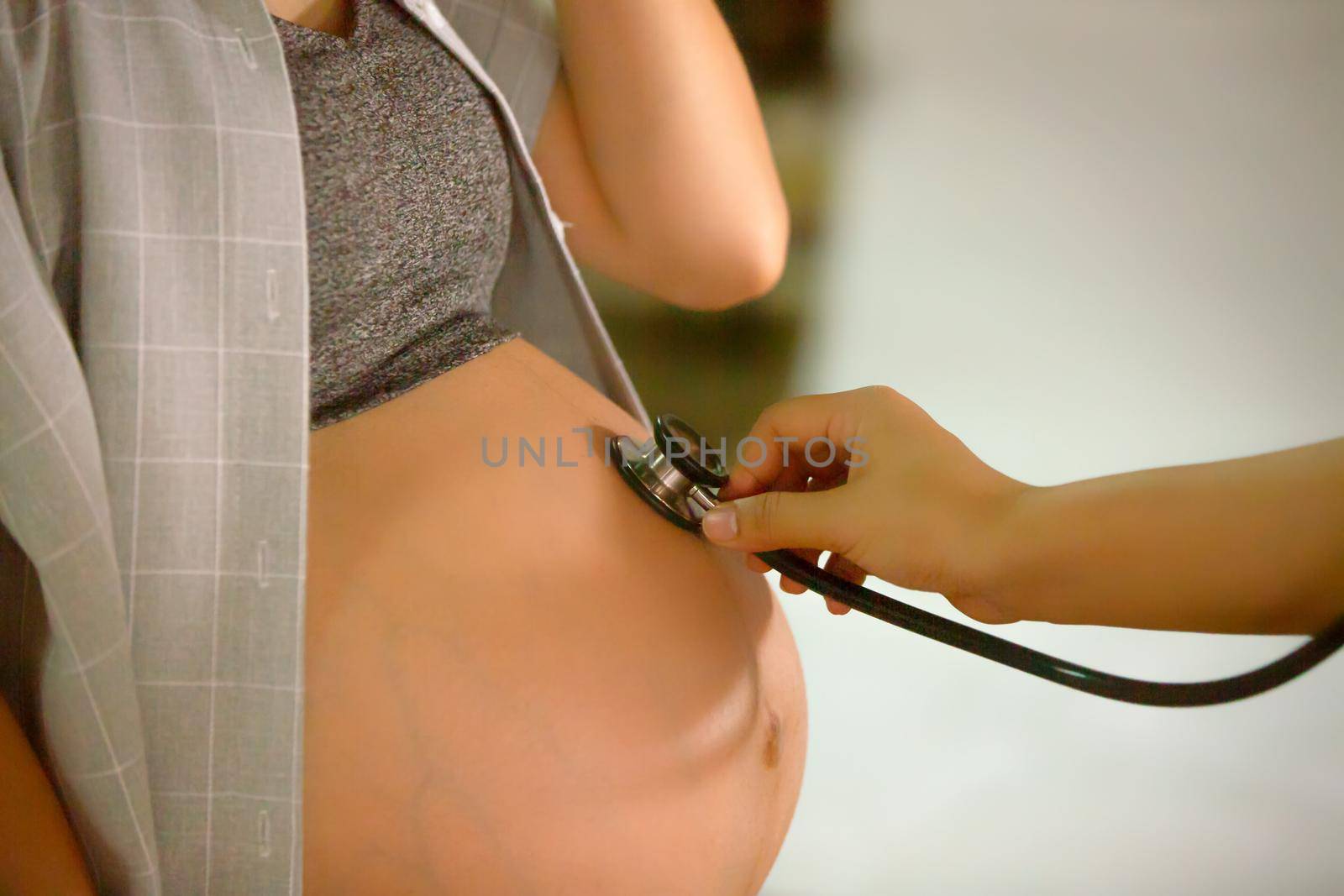 Cropped Hand of Examining Pregnant Woman Belly With Stethoscope