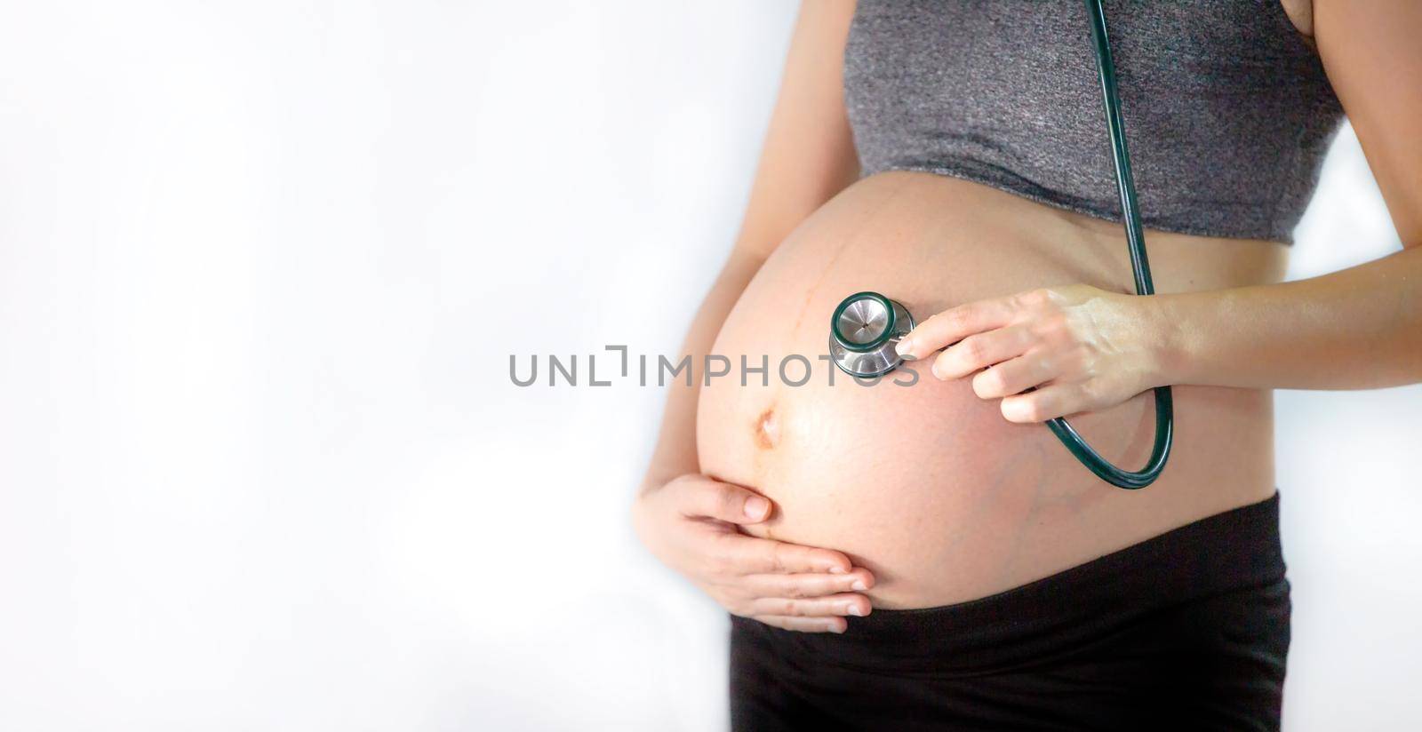 Cropped Hand of Examining Pregnant Woman Belly With Stethoscope