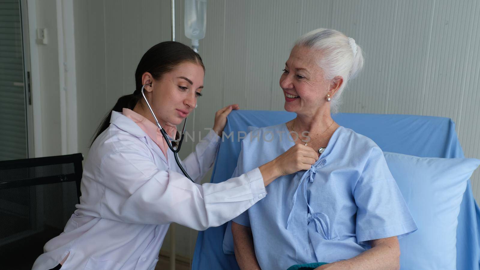 women doctor and elderly patient by chuanchai