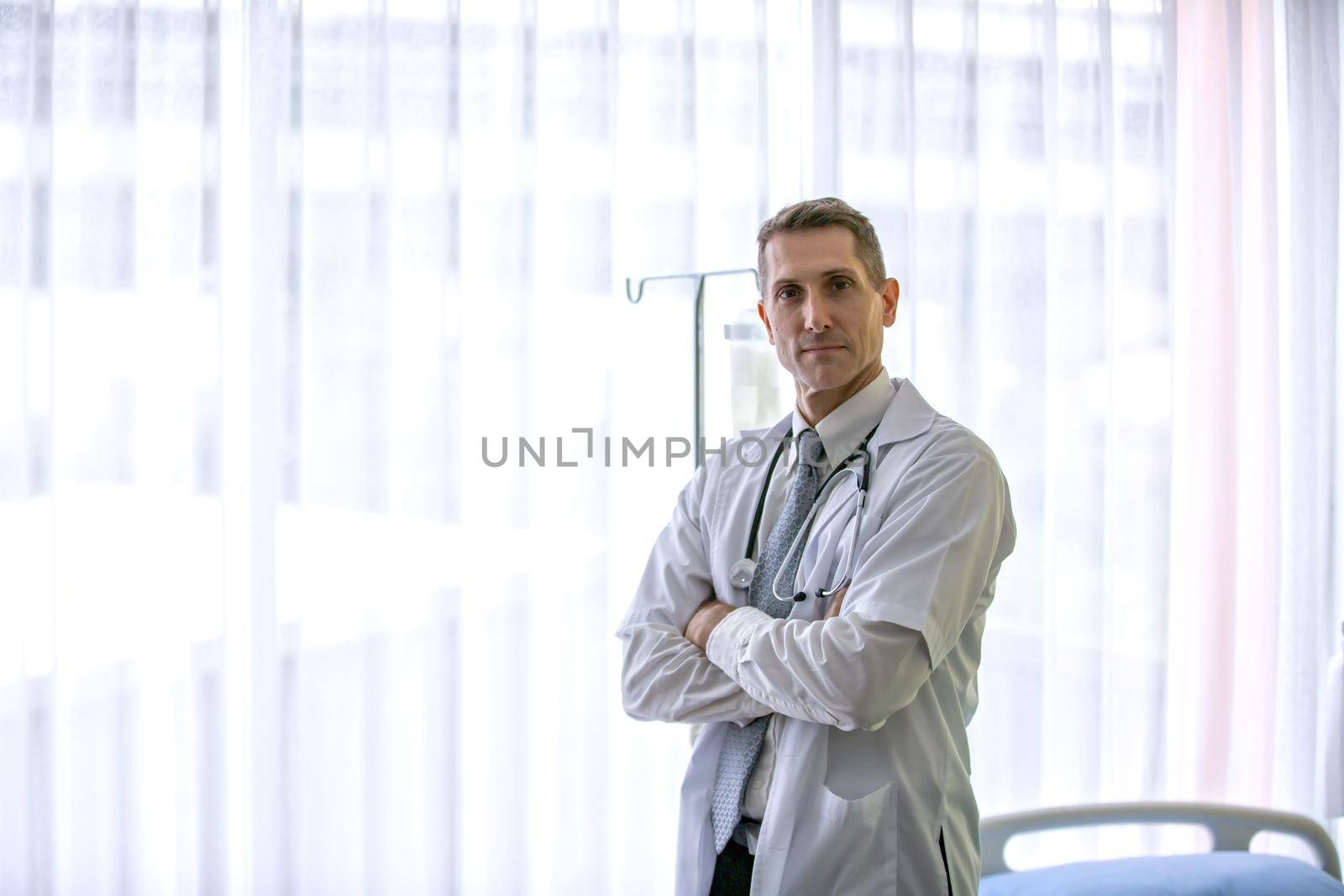 portrait of male doctor standing with confidence in hospital.