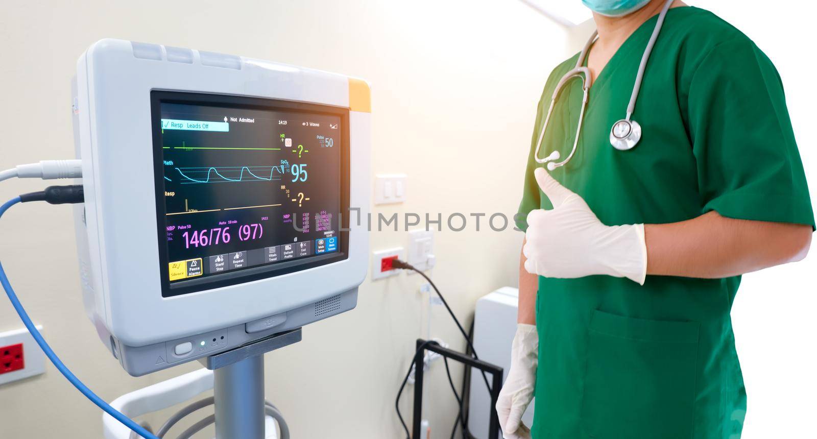 Healthcare and medical concept. Medicine doctor with stethoscope and gloves in hand and EKG Monitor 
 with pulse electrocardiogram in  hospital.