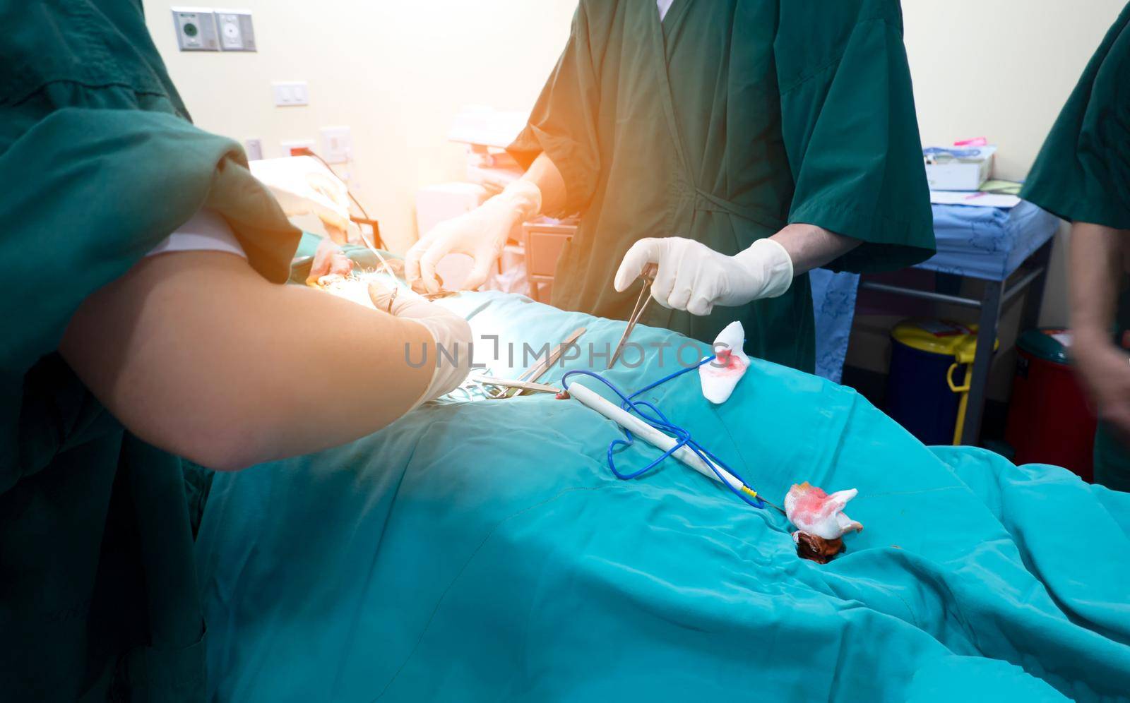 Midsection of surgery team operating Medical Team Performing Surgical Operation in Modern Operating Room
or Group of surgeons in operating room with surgery equipment.