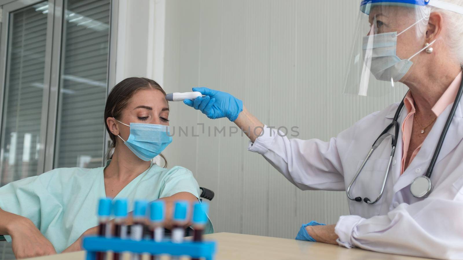 Coronavirus protection during the quarantine, Female doctor doing medical exam to a women patient. by chuanchai