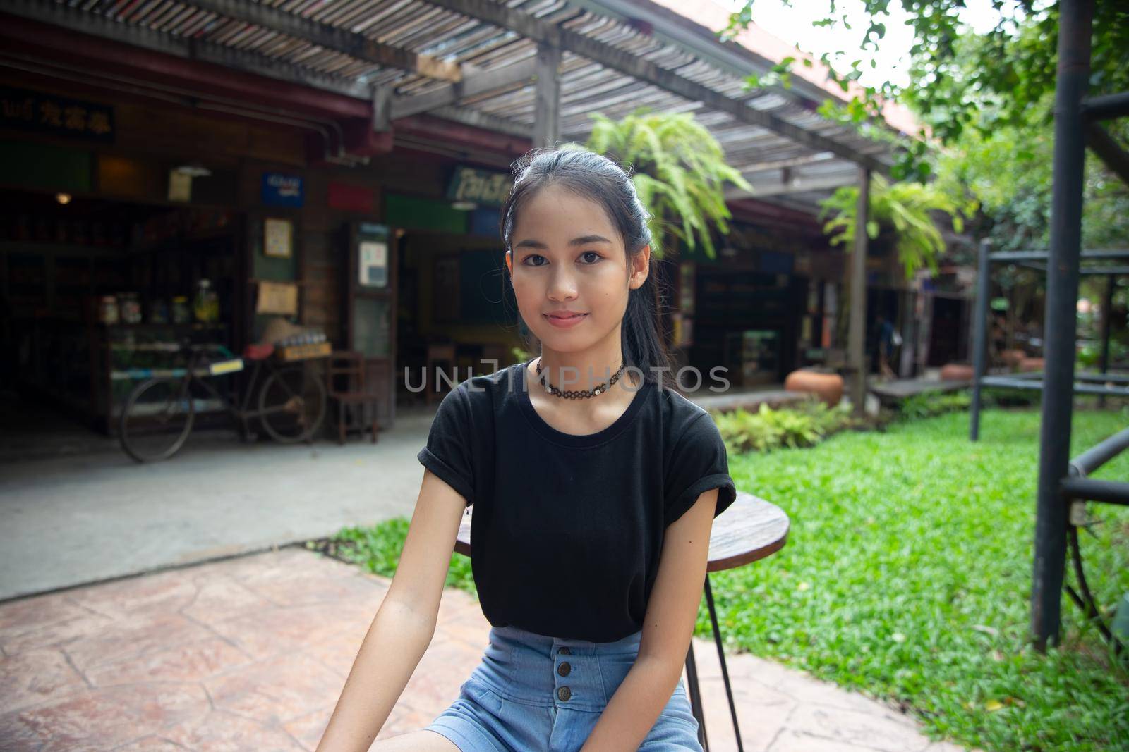 Young attractive smiling woman practicing yoga pose, working out, wearing sportswear pants, bra, full length, outdoor. by chuanchai