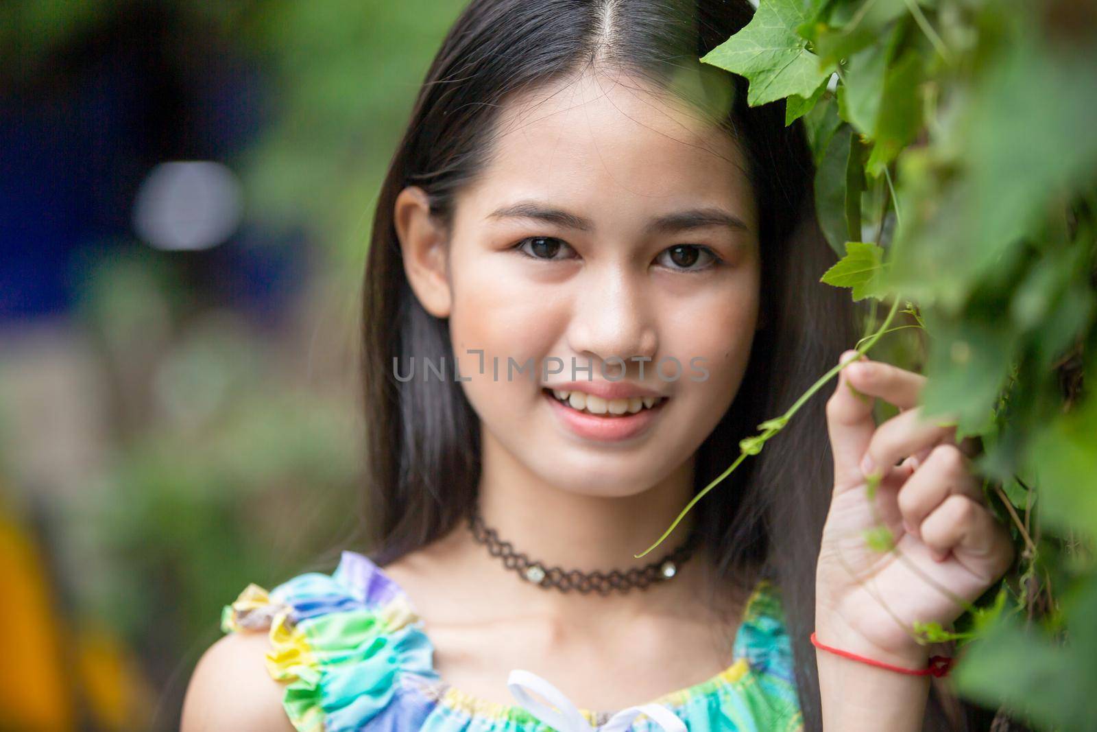 portrait of young charming beautiful girl with smile, authentic moments of real emotion. by chuanchai