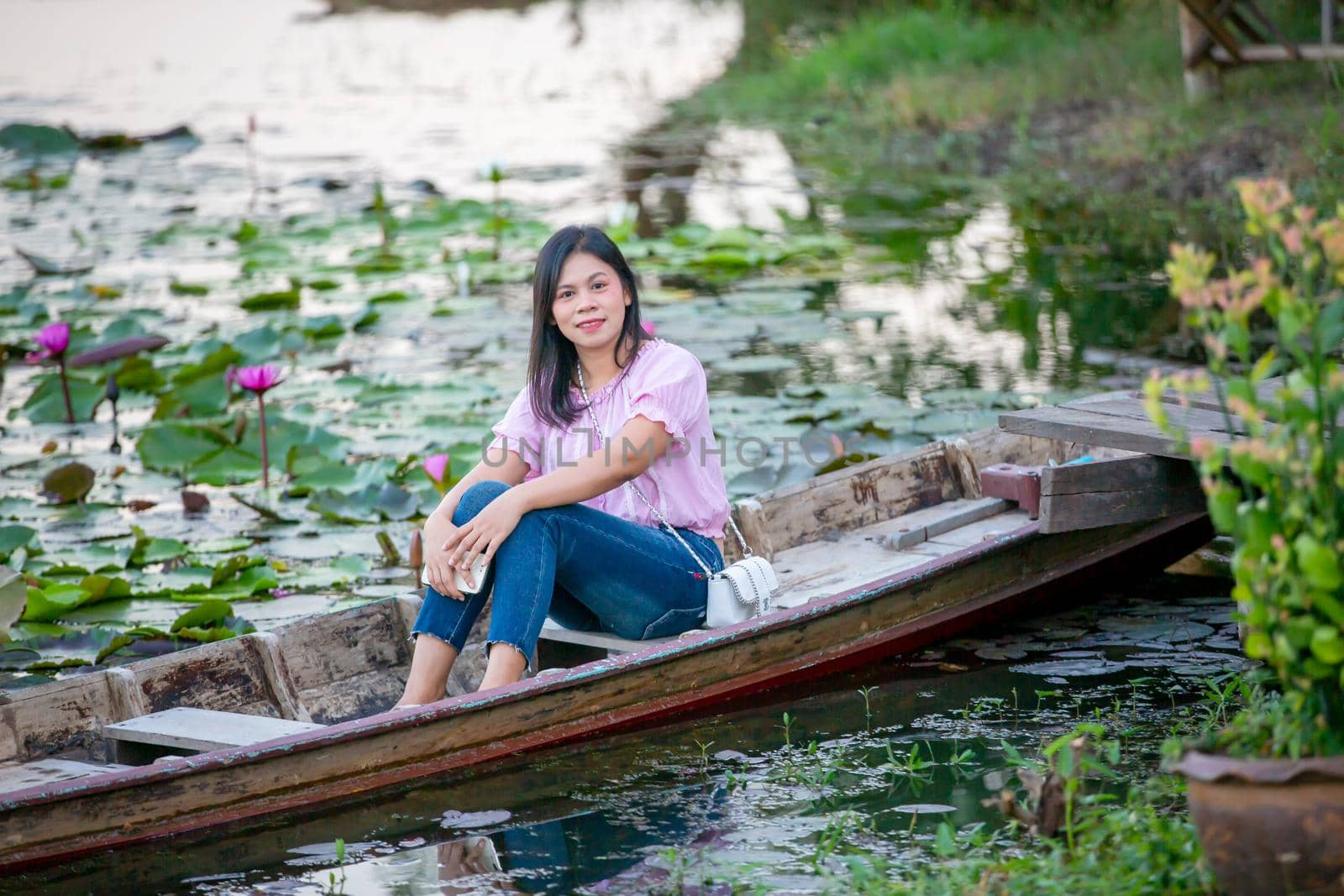 Portrait Of Smiling Young Woman sitting on boat at Outdoors
