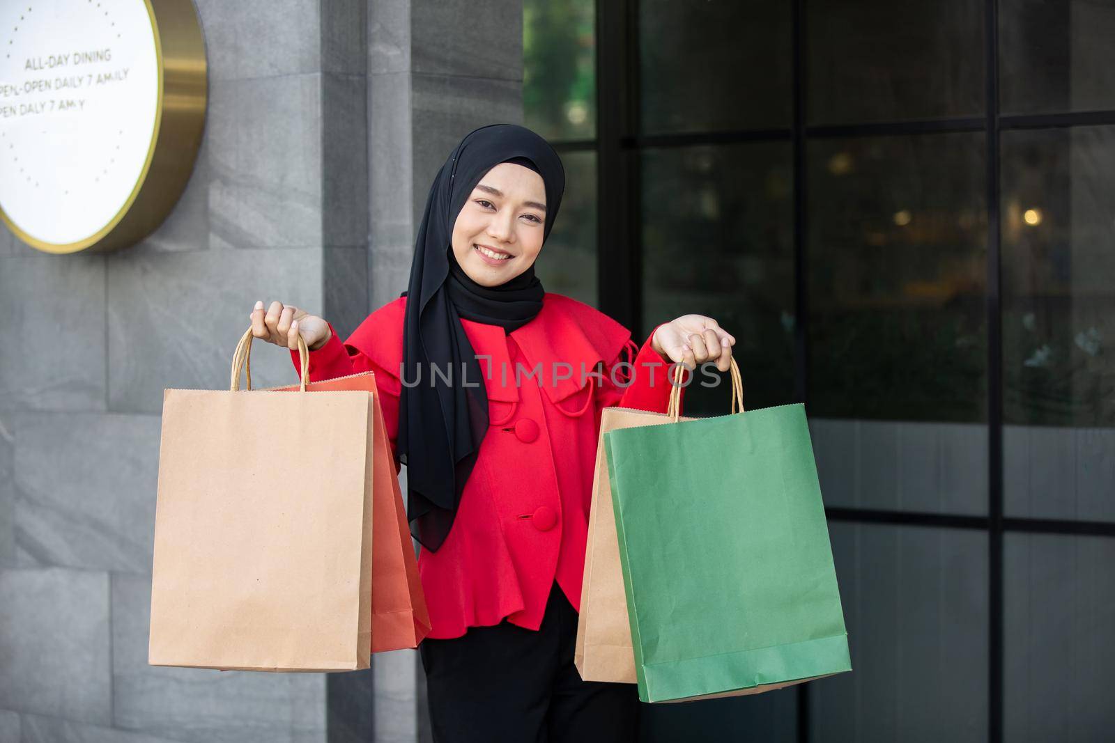 Cheerful young women holding shopping bag at outdoor.