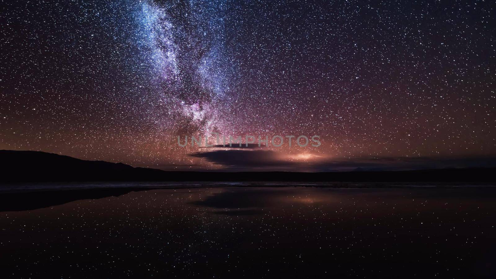 Night landscape with colorful Milky Way and yellow light at mountains. Starry sky with hills at summer. Beautiful Universe. Space background by chuanchai