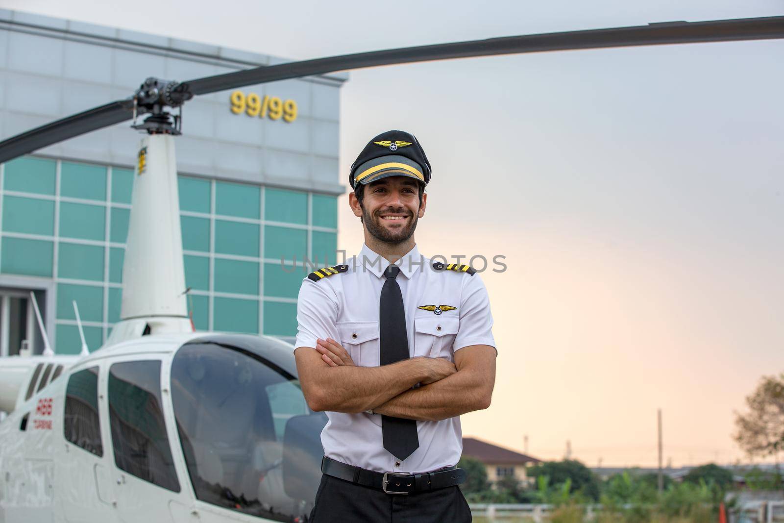 Shot of a mature Helicopter pilot using a headset while traveling in a helicopter, Business people traveling by helicopter