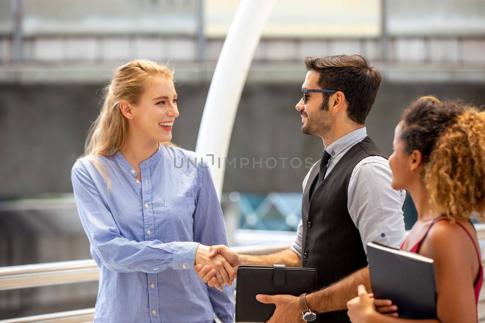 Business people shaking hands, finishing up a papers signing. Meeting, contract and lawyer consulting concept.