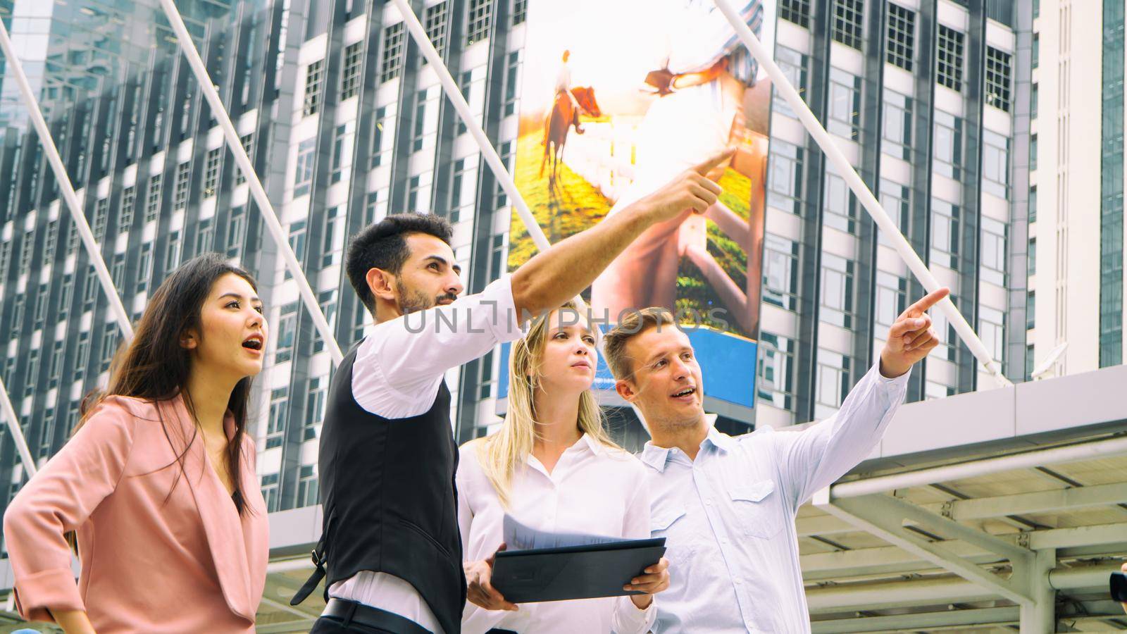 Everyday winners. Group of happy business people in smart casual wear looking at the laptop and gesturing. Achieving success. by chuanchai