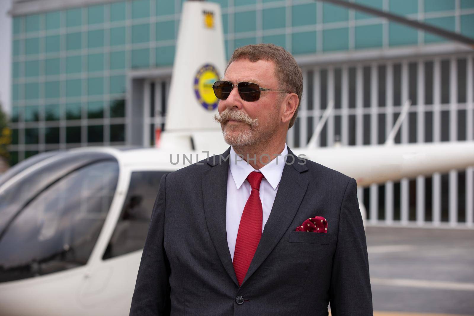 Business people traveling by helicopter , Shot of a mature businessman using a headset while traveling in a helicopter