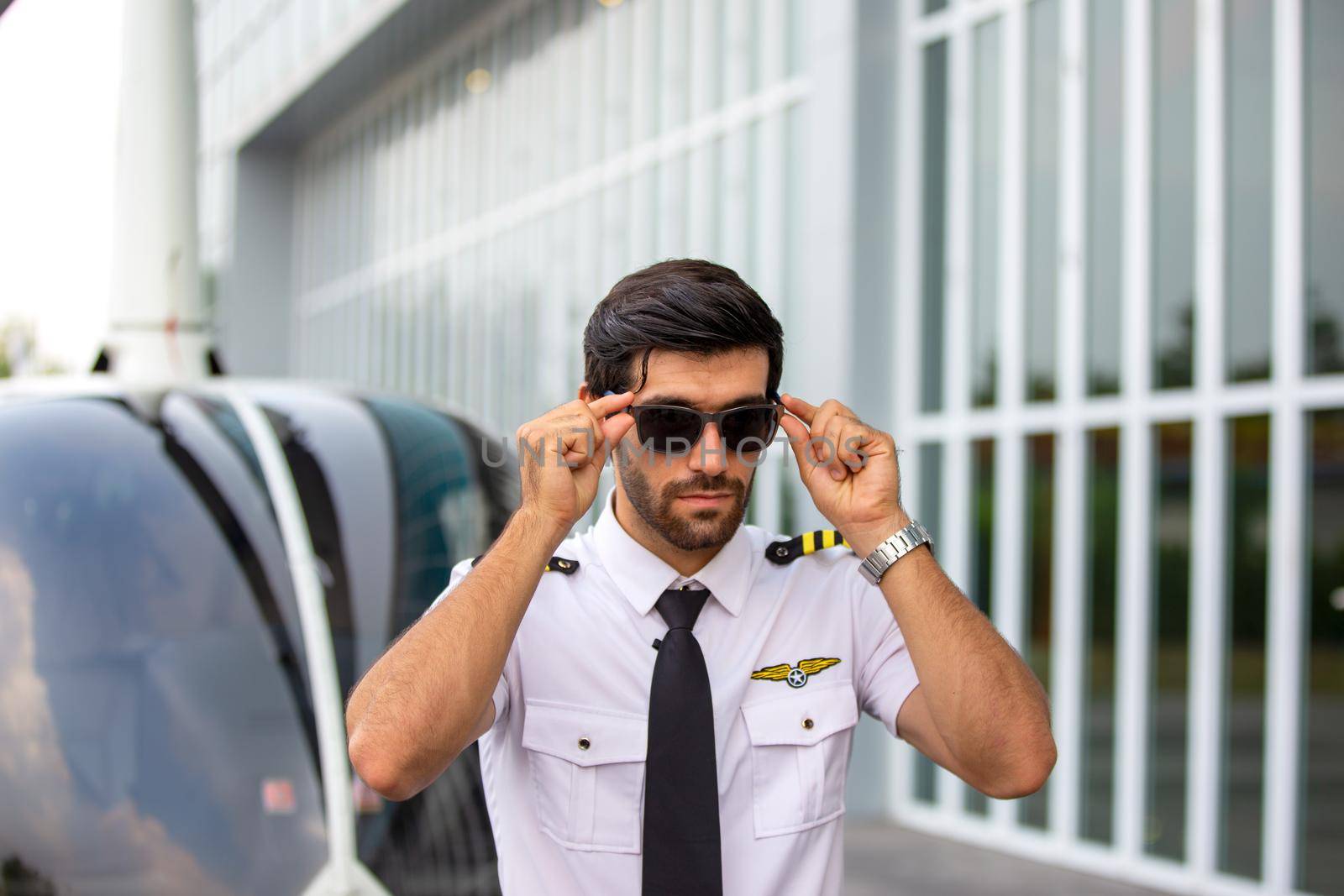 Shot of a mature Helicopter pilot using a headset while traveling in a helicopter, Business people traveling by helicopter