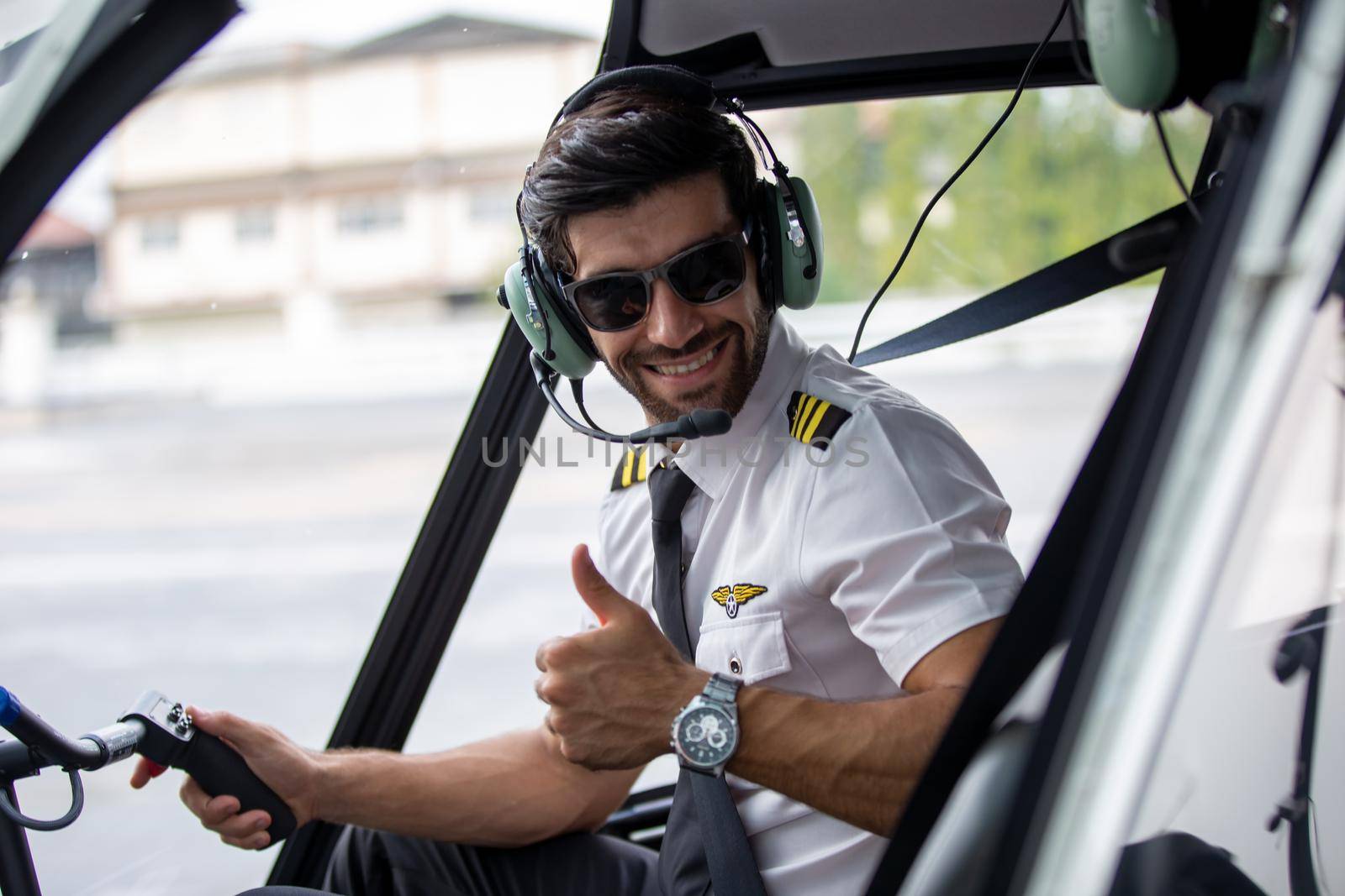 Shot of a mature Helicopter pilot using a headset while traveling in a helicopter, Business people traveling by helicopter