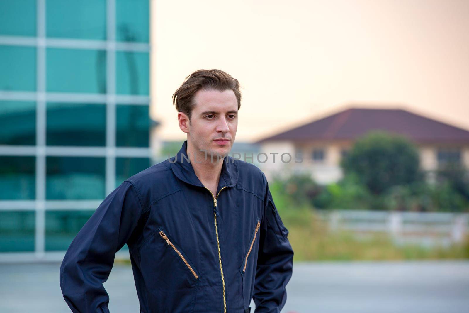 Commercial man pilot in technician suit standing in front of helicopter after check and maintenance engine	 by chuanchai