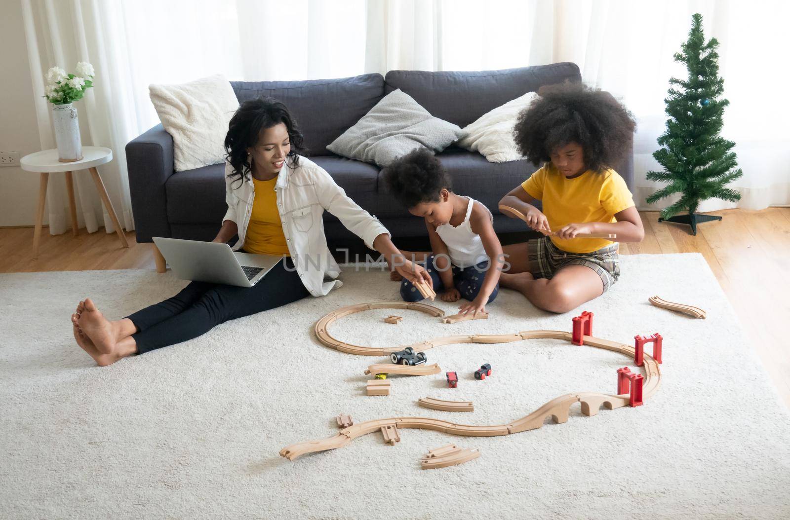 Mix race of family, dad, mom and daughters play together in living room by chuanchai