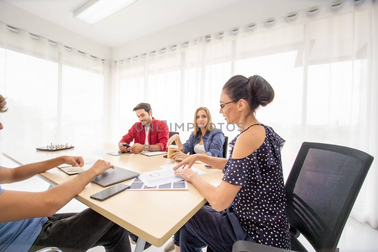 Business people working in office on desktop computer, Group of happy business people in smart casual wear looking at the laptop and gesturing. Achieving success. by chuanchai