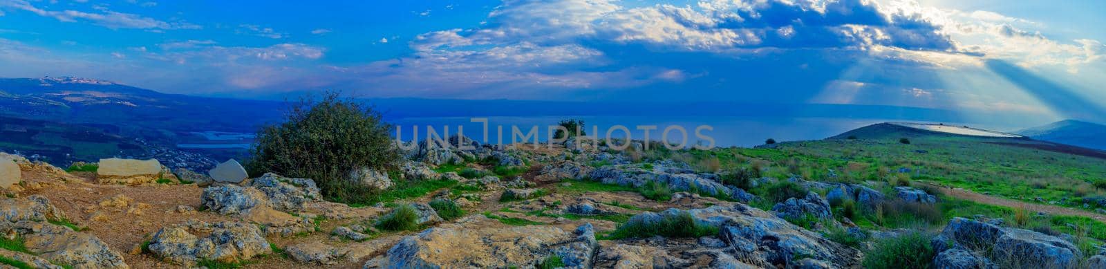Panoramic morning view of the Sea of Galilee, with Sun beams, from the west (mount Arbel). Northern Israel. Text is Observation point name and directions