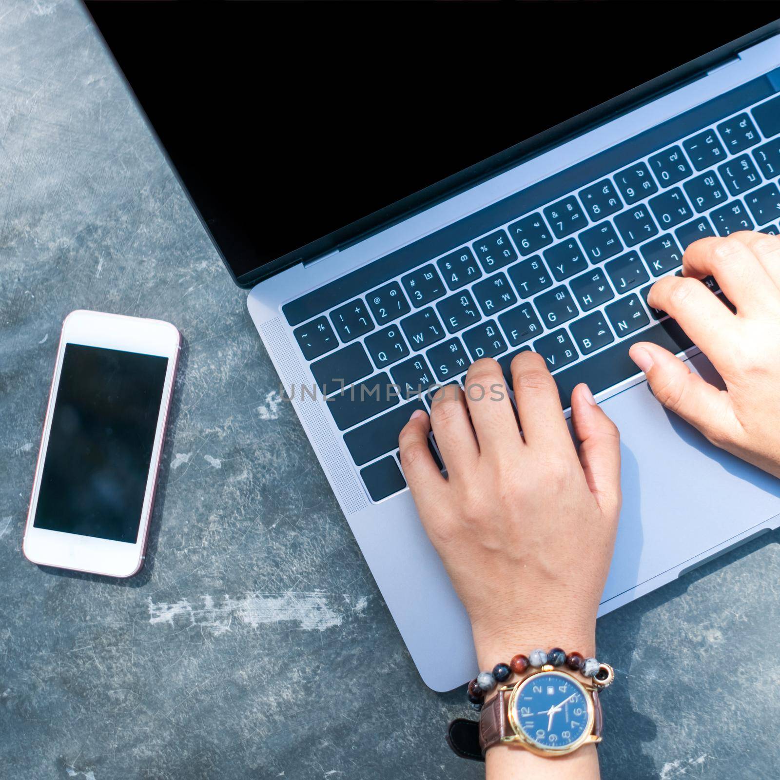 Woman using laptop and smartphone to work study in vacation cady at beach background. Business, financial, trade stock maket and social network concept.