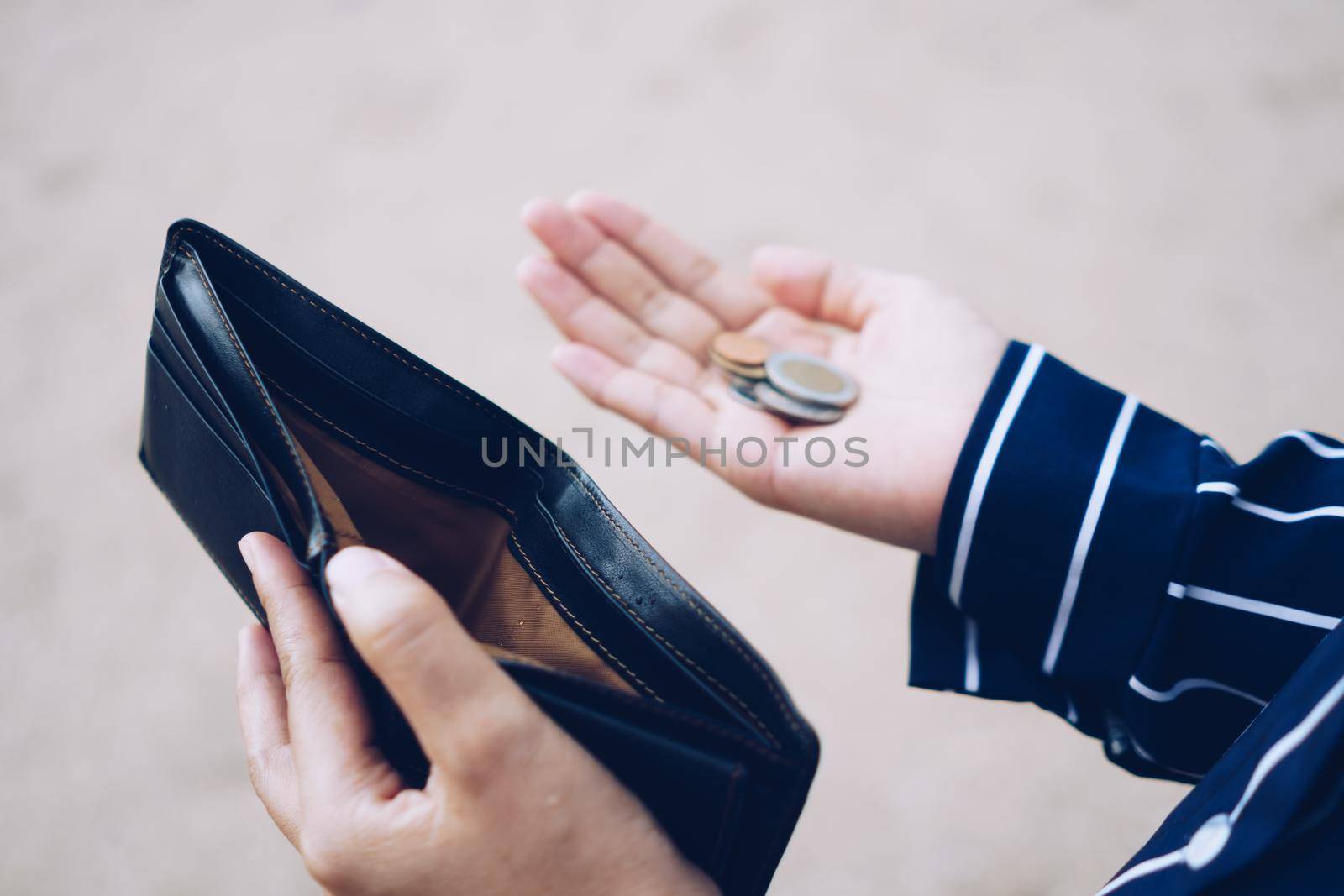 Woman holds an empty purse and coins in hand meaning money financial problem or bankrupt jobless, broke after credit card payday jobless, debt concept.