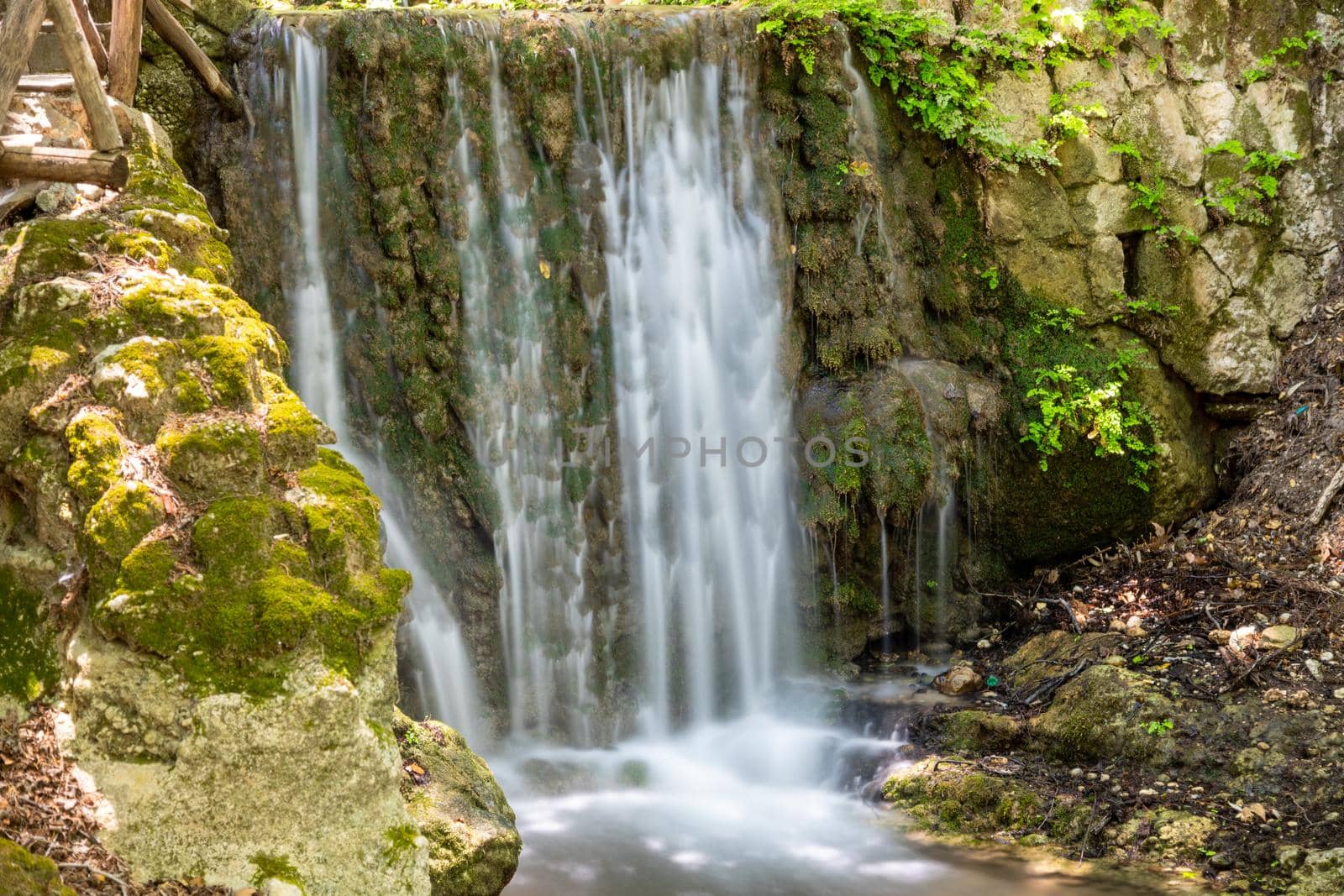 Waterfall in the valley of butterflies (Petaloudes) on Rhodes island, Greece  by reinerc