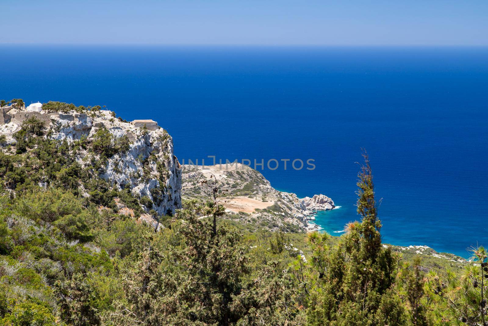 Scenic view at landscape and rocky coastline near Monolithos on Greek island Rhodes with the aegaen sea in the background by reinerc