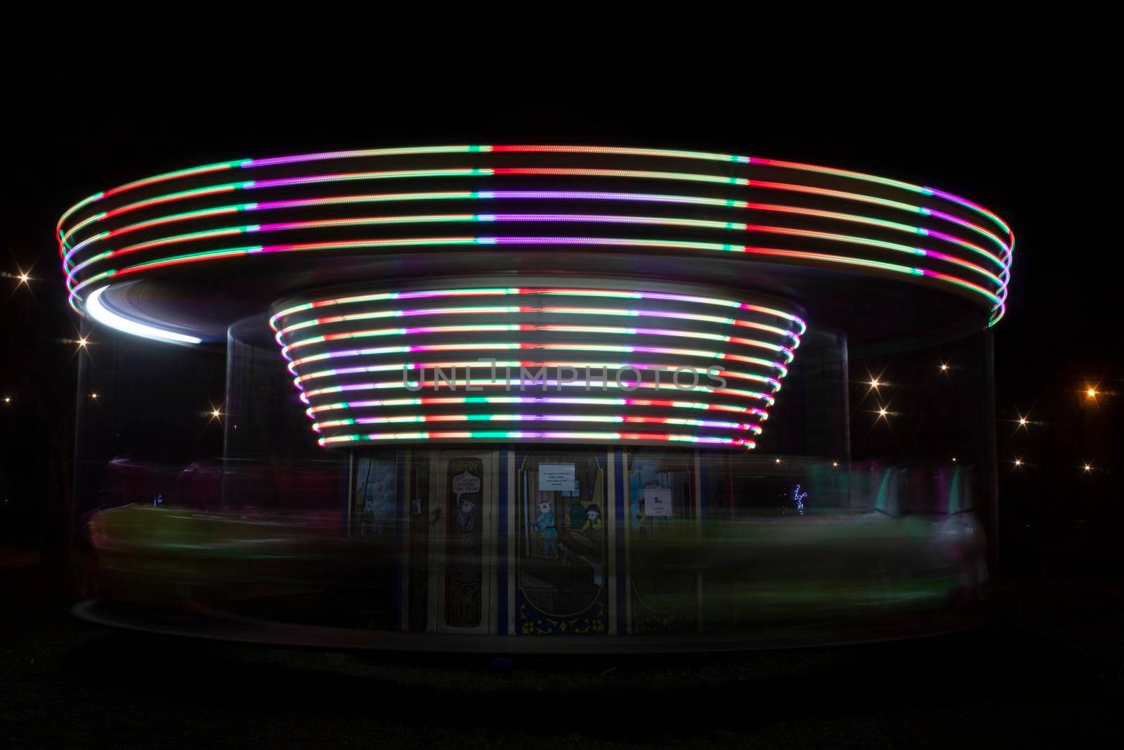 A colorful carousel spinning with a long exposure time