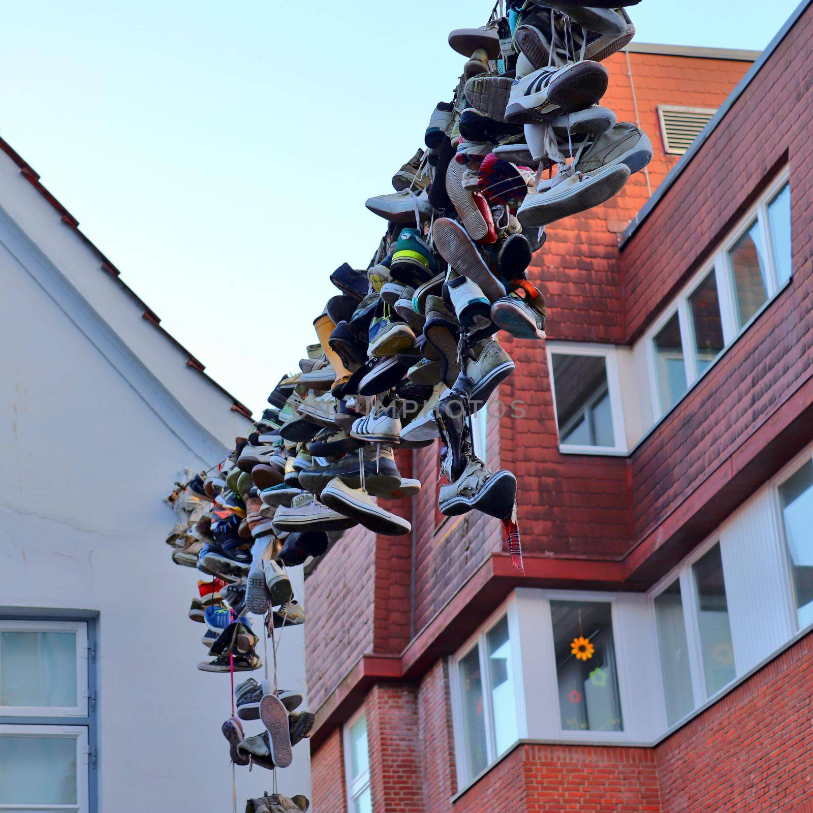 Shoes hanging between old houses in the german northernmost town called Flensburg by MP_foto71