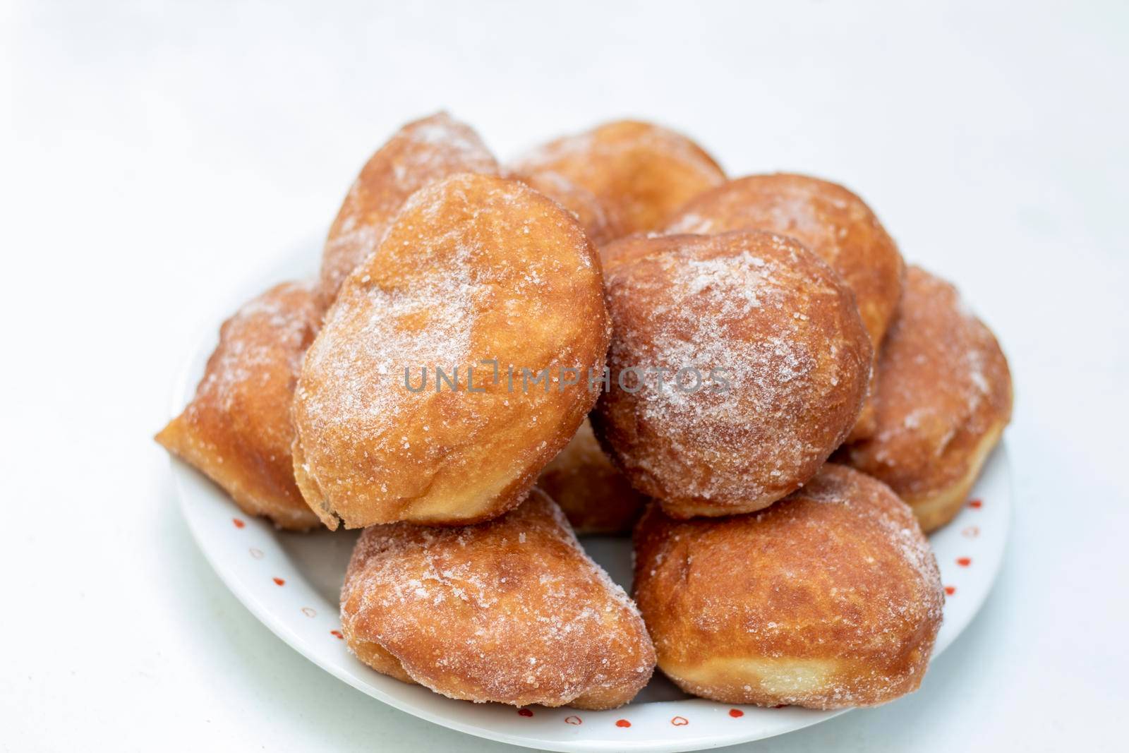 Homemade donuts full of sugar on the plate by bybyphotography