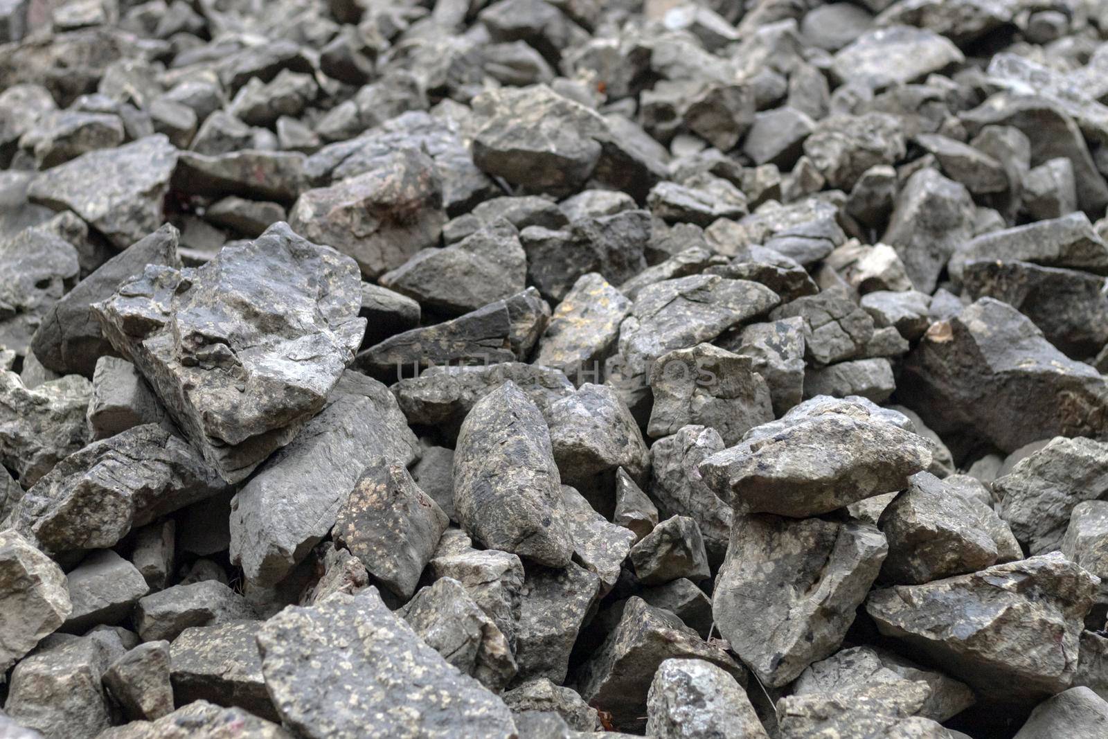 Stones scattered on the floor, building materials, texture by bybyphotography