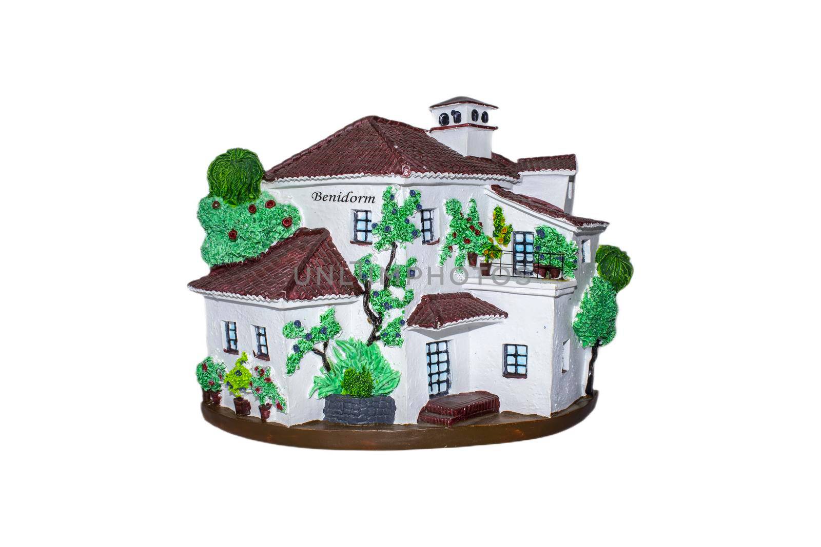 A decorative house shaped souvenir from Benidorm, Spain, on a white background