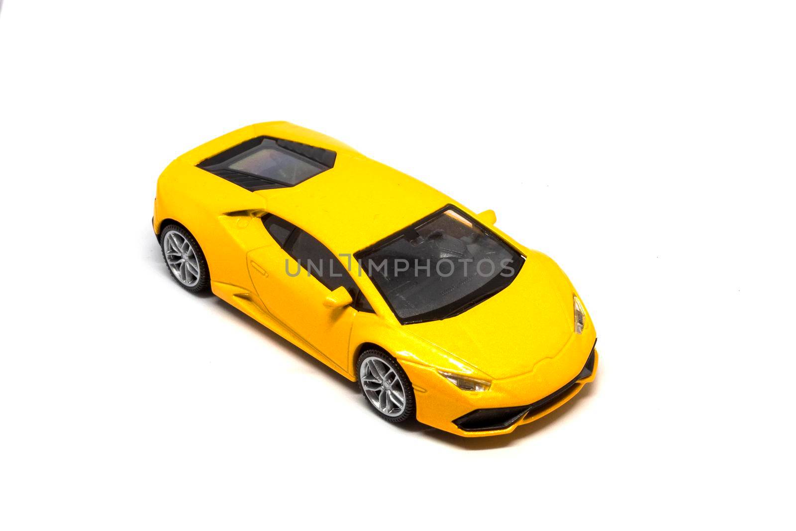 A super yellow car isolated on a white background by bybyphotography