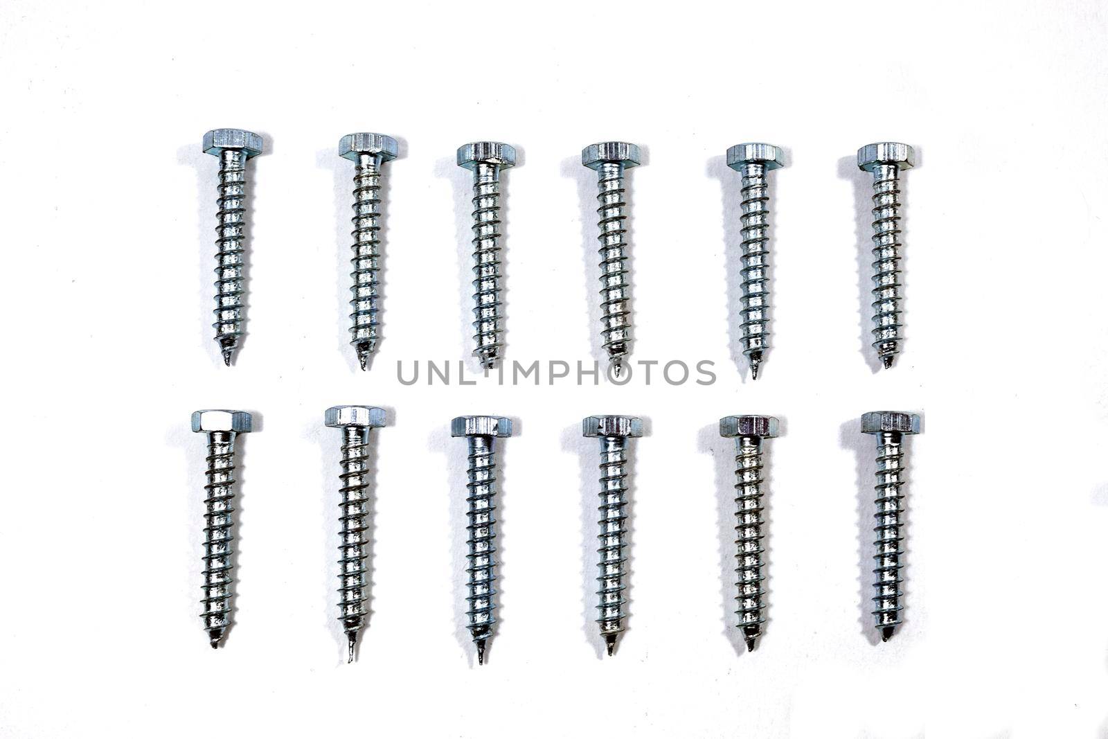 A set of new screws on a white background by bybyphotography