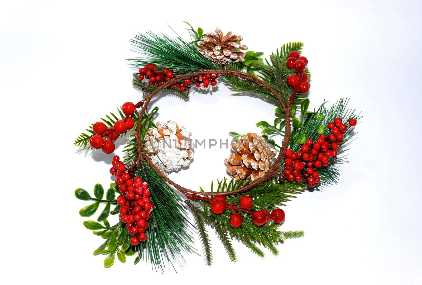 Decorative Christmas wreath with berries and cones by bybyphotography