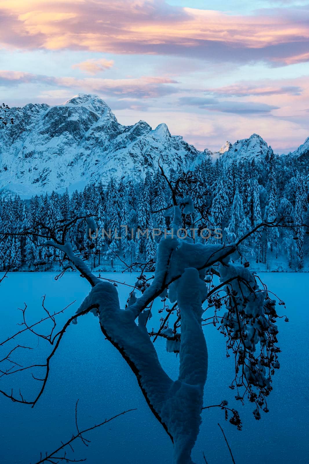 the panorama of the lake of Fusine, Tarvisio, frozen in winter