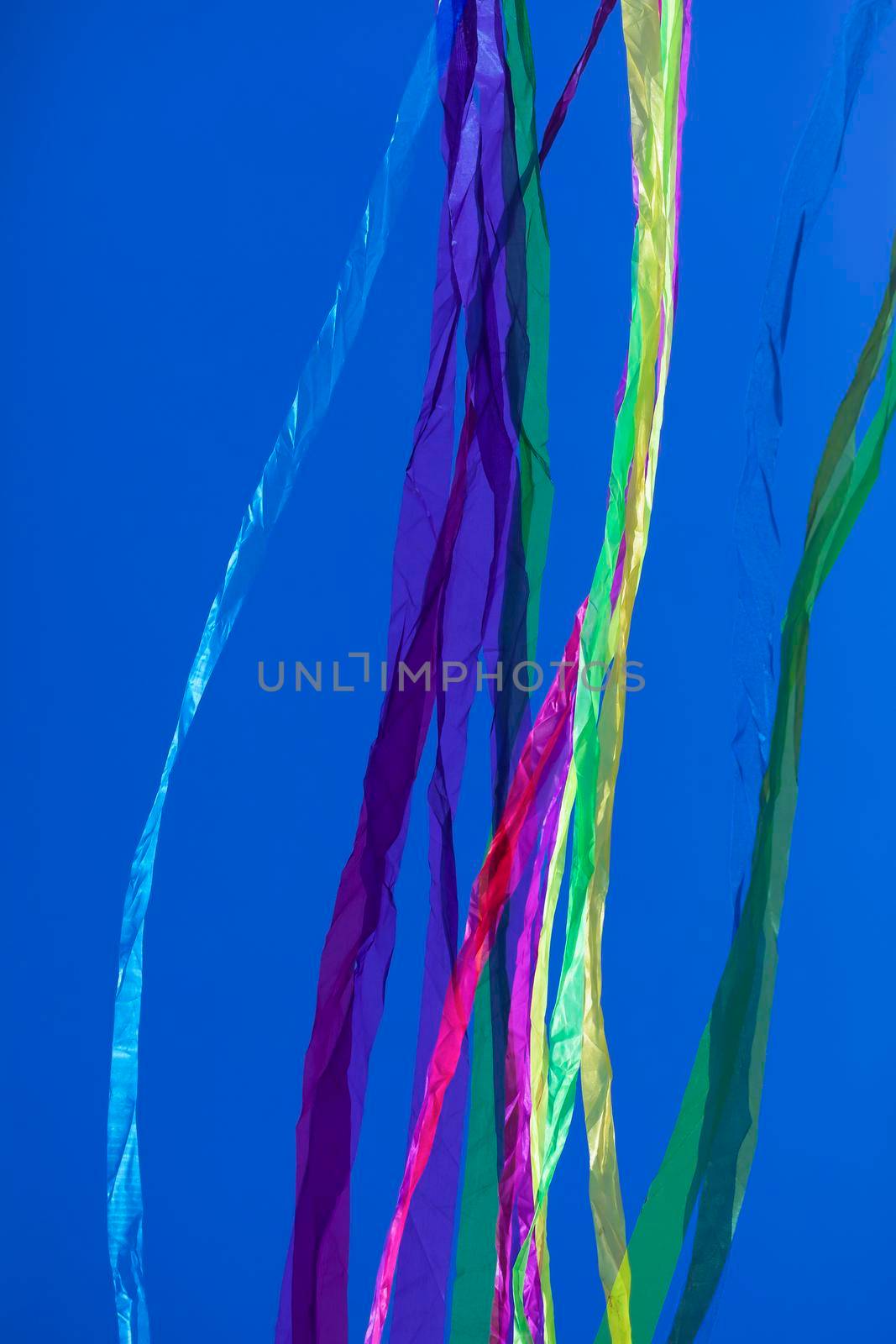 Colored ribbons and lines, floating on a plain background. by alvarobueno