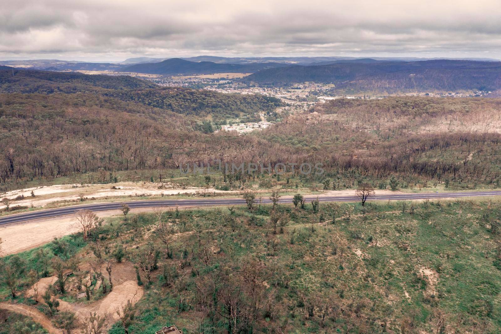 Aerial photograph of a highway and a forest after bushfires in regional Australia by WittkePhotos