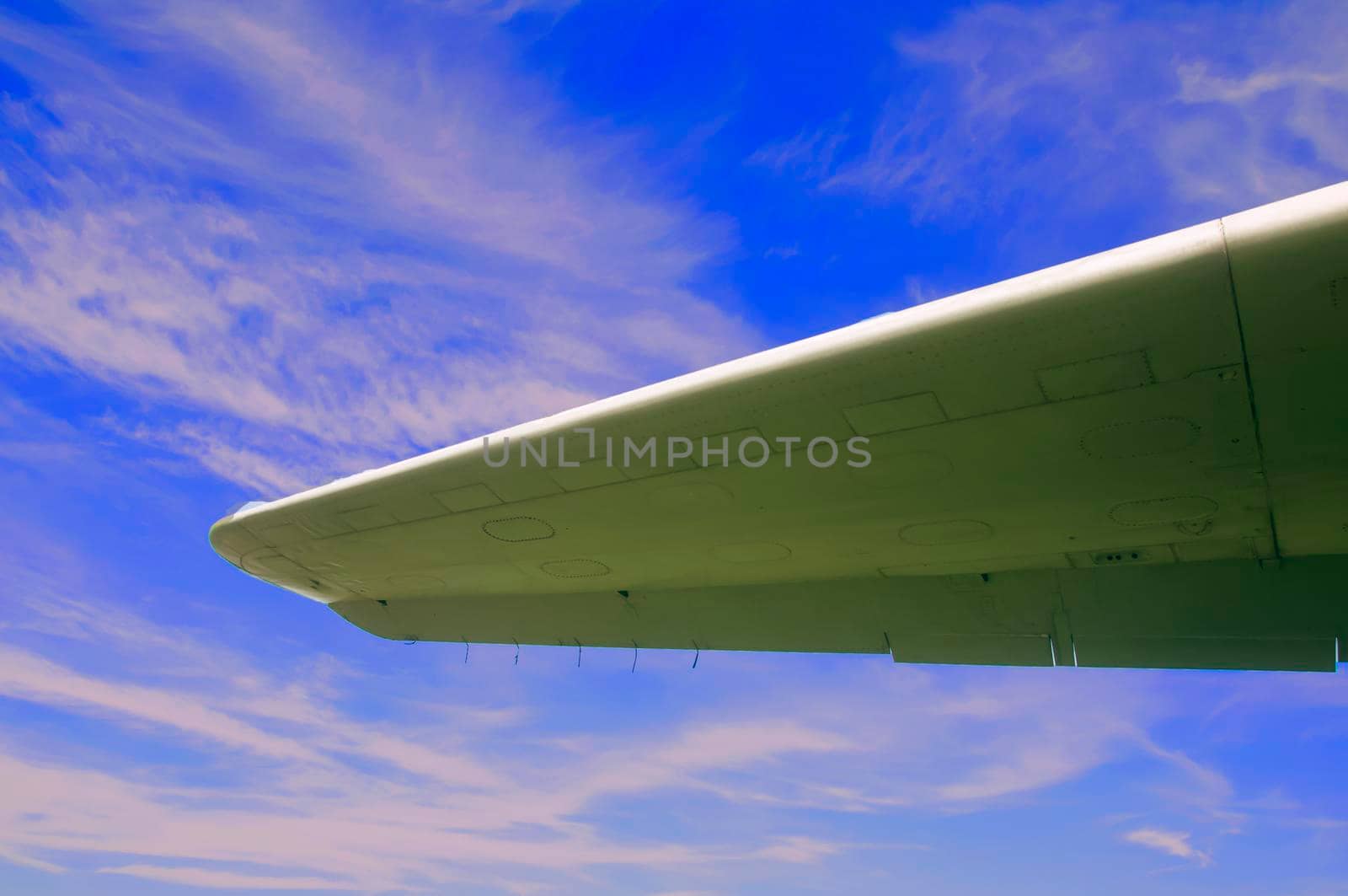 Aircraft wing on the blue sky background, summer