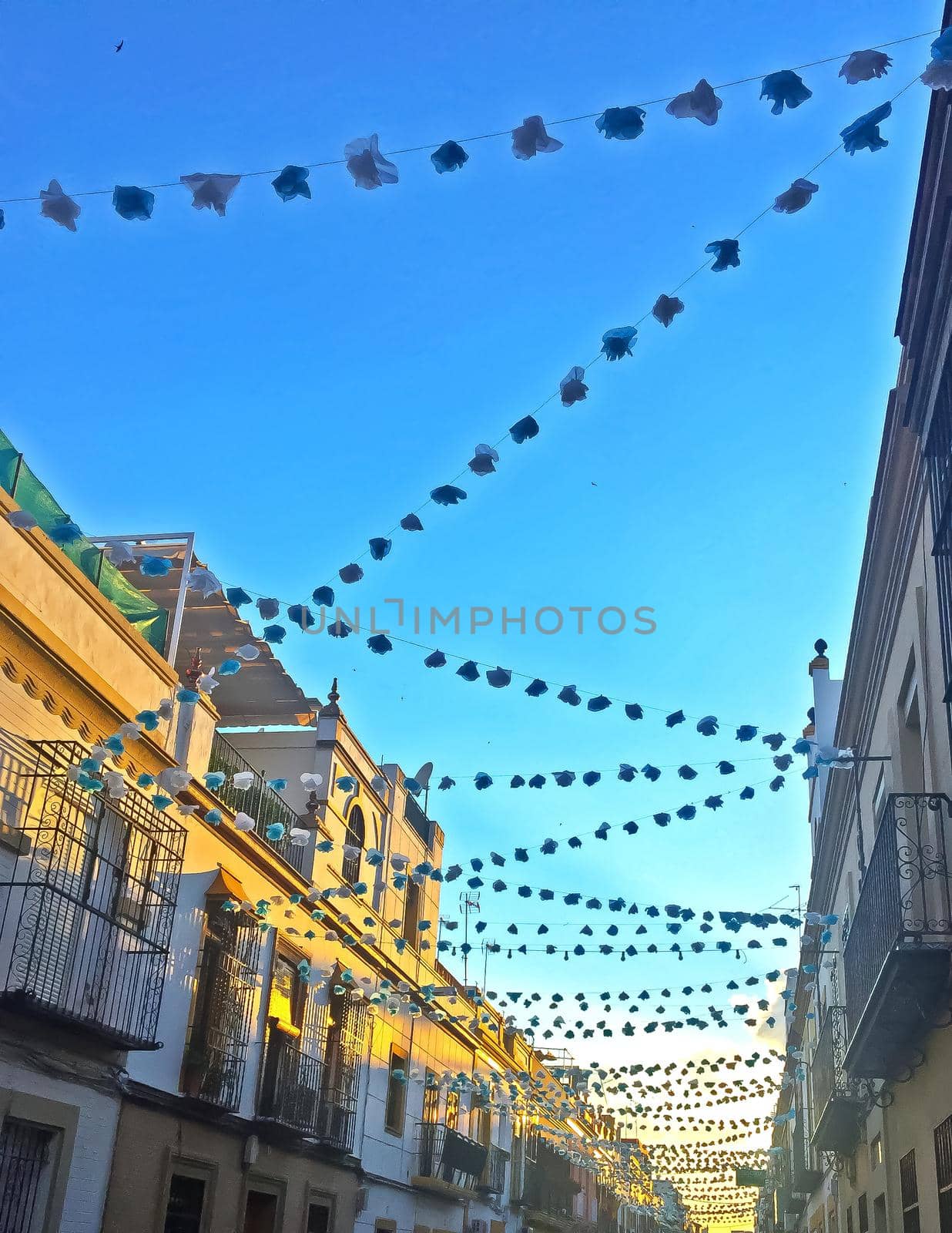 Street decorated of garlands for the holidays, summer, Seville, Spain