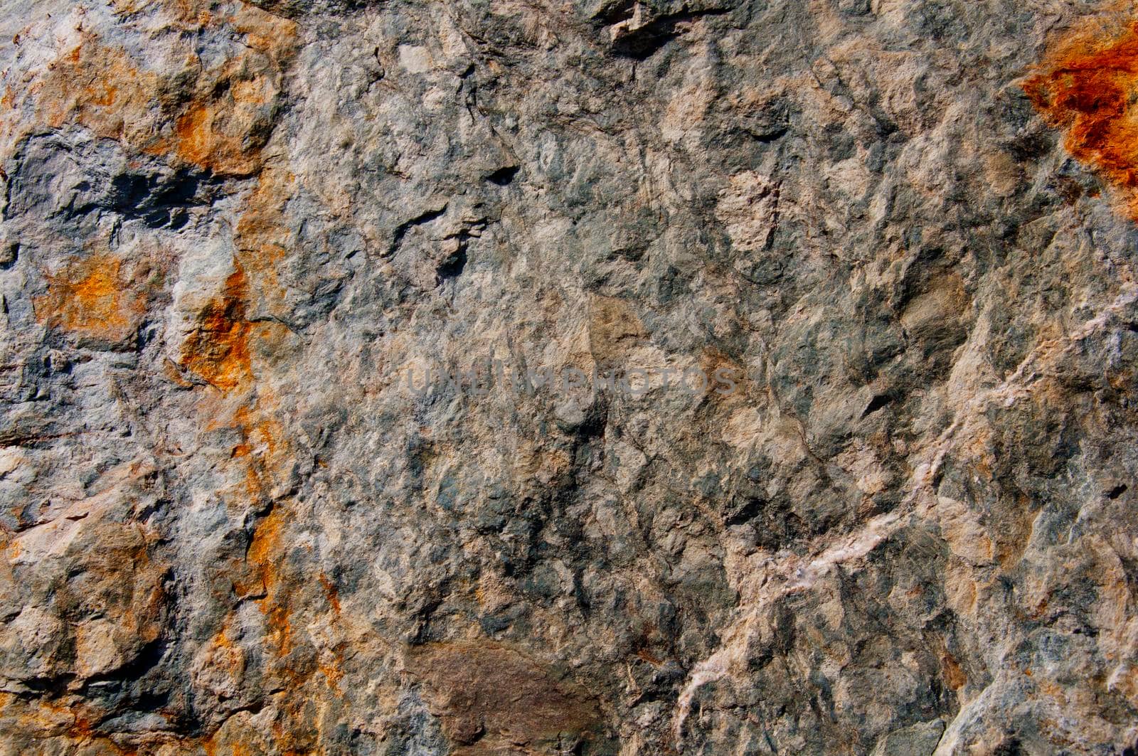 Grey stone surface with rusty marks