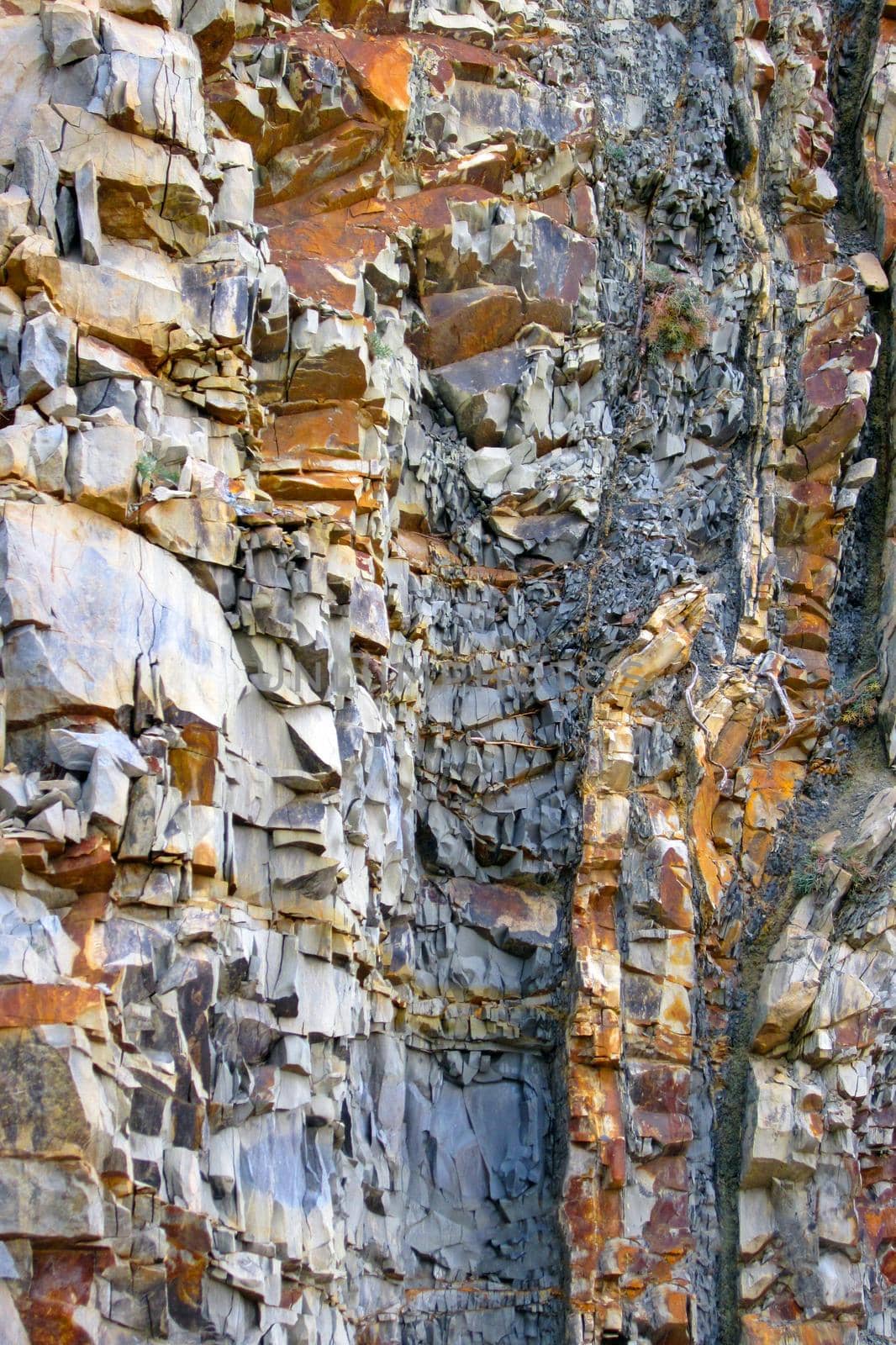 Natural interesting structured rock wall,  patchy surface