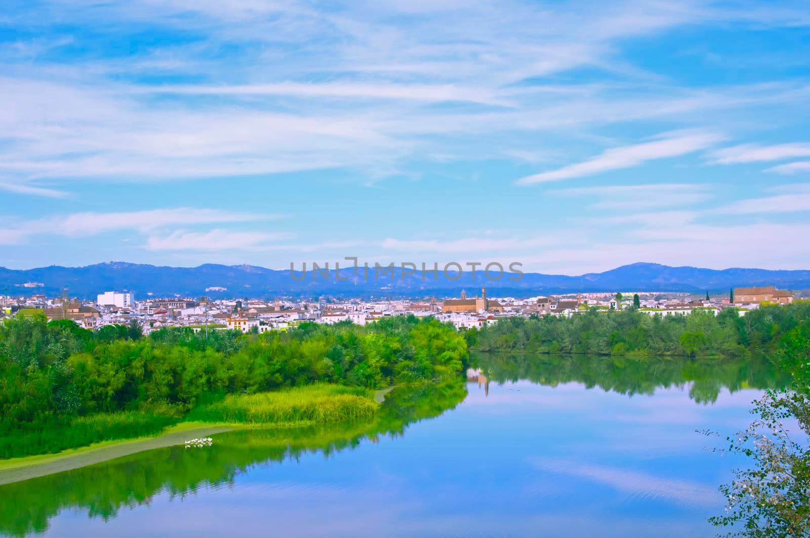 City view with mountains, river and blue sky