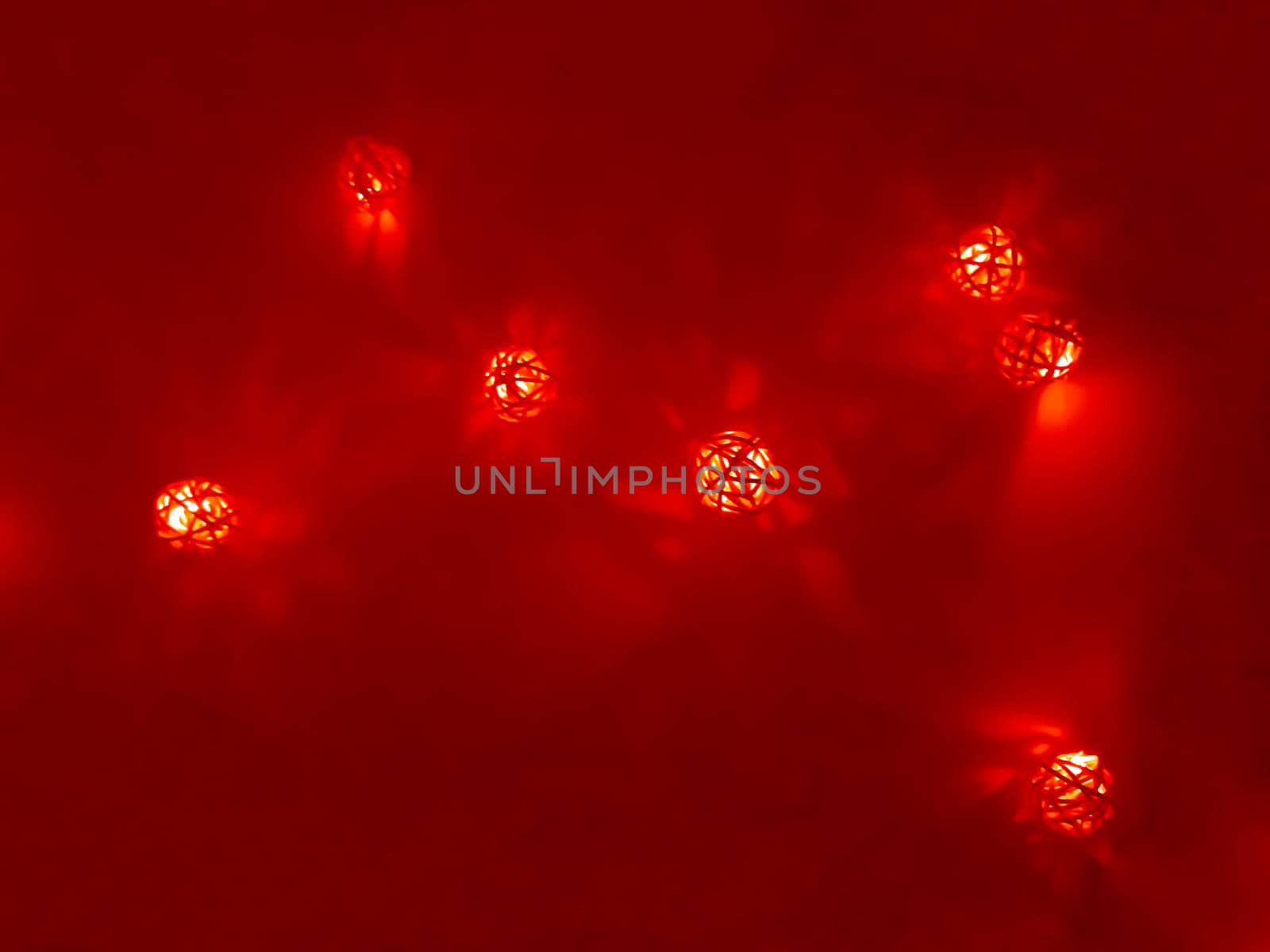 Red garland of small decorative luminous balls, night time