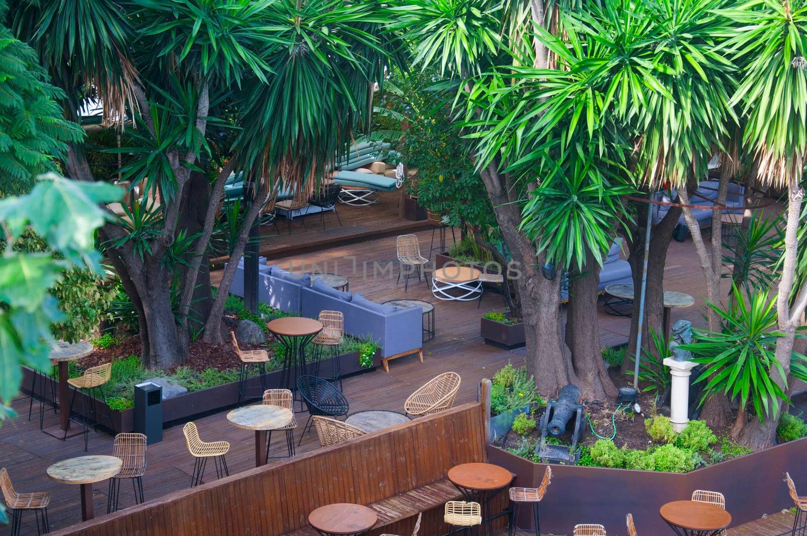 View of outdoor restaurant with green trees, close-up, summer