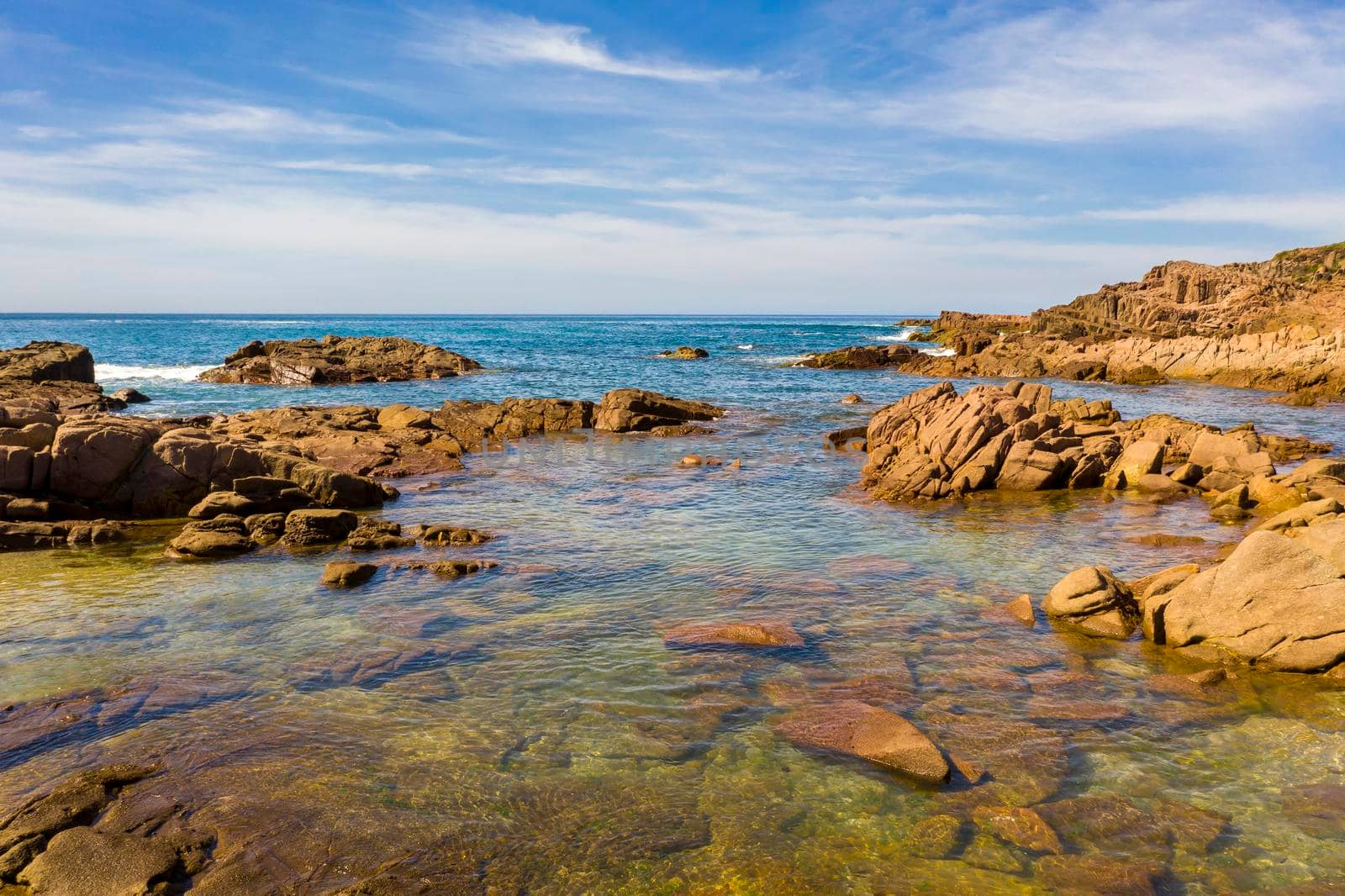 Aerial view of the brown Rocks and blue water of the Tasman Sea at Birubi Point near Port Stephens in regional New South Wales in Australia