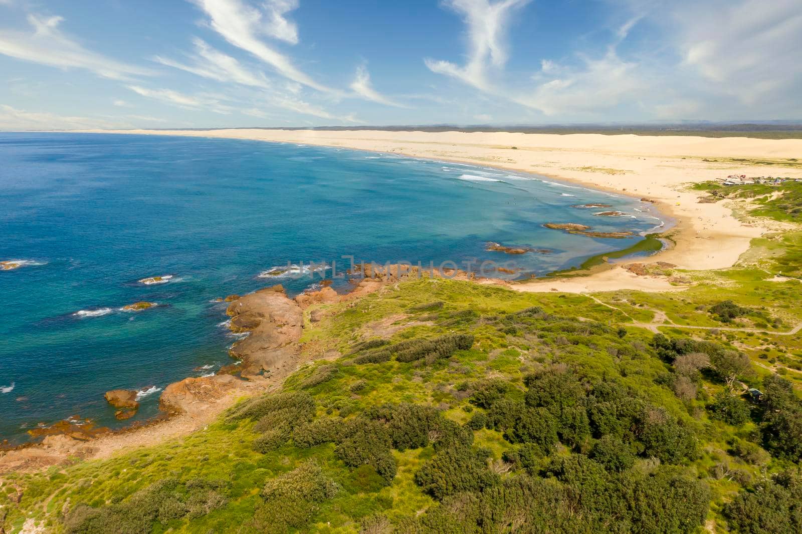 Aerial view of the Stockton Sand Dunes and blue water of the Tasman Sea at Birubi Point near Port Stephens in regional New South Wales in Australia