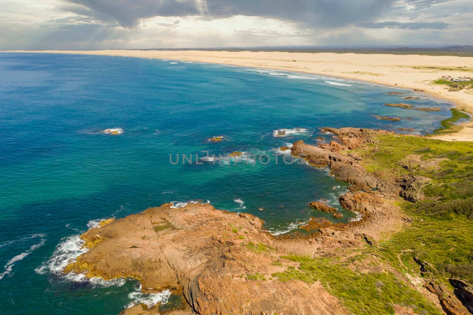 Aerial view of the Stockton Sand Dunes and blue water of the Tasman Sea at Birubi Point near Port Stephens in regional New South Wales in Australia