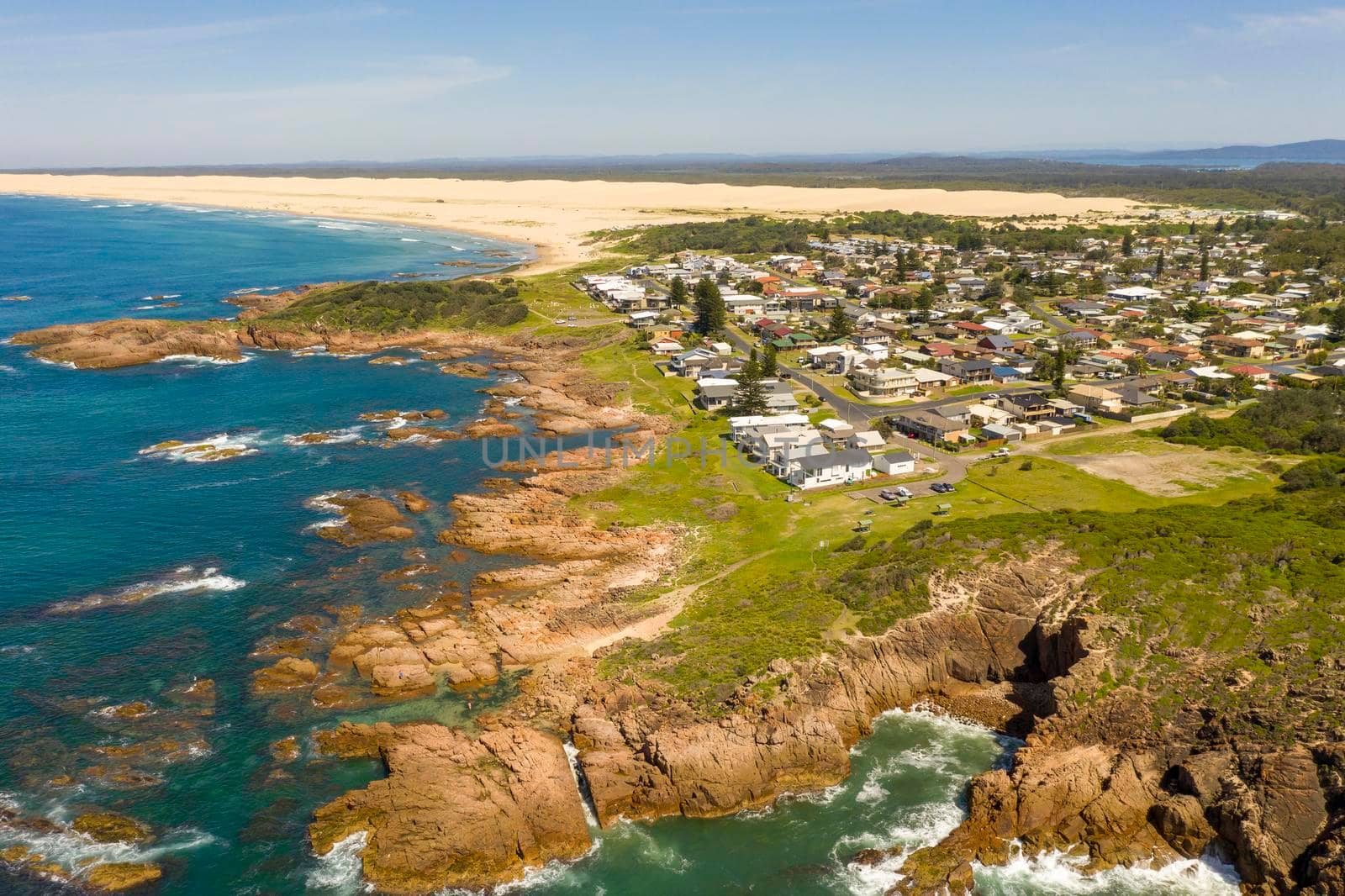 Aerial view of the Stockton Sand Dunes and blue water of the Tasman Sea at Birubi Point near Port Stephens in regional New South Wales in Australia